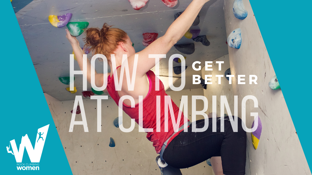 Woman climbing a rock climbing wall.